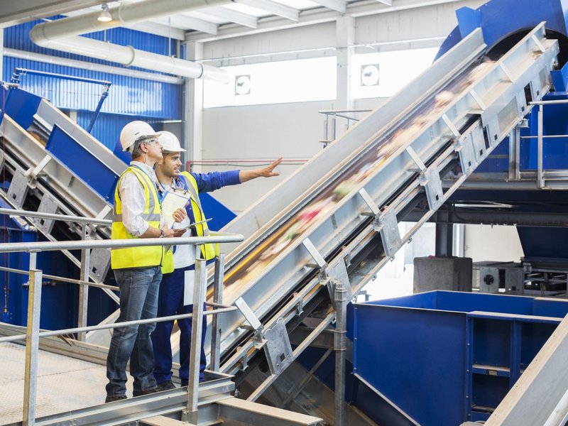 Workers talking in recycling center